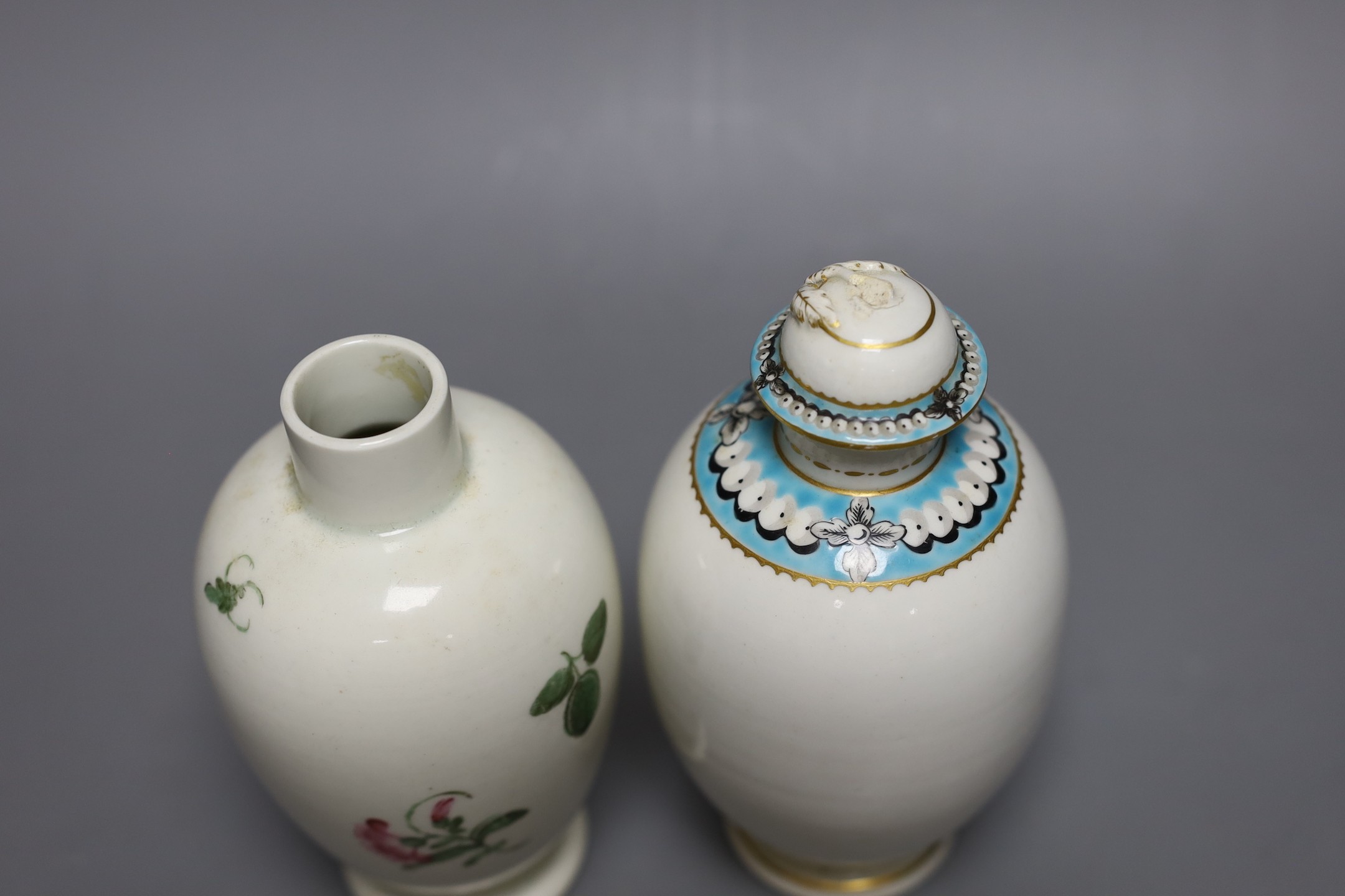 A Worcester tea canister and cover painted with ‘pearls’ in a turquoise band and another Worcester tea canister painted with flowers, 15 cms high including cover